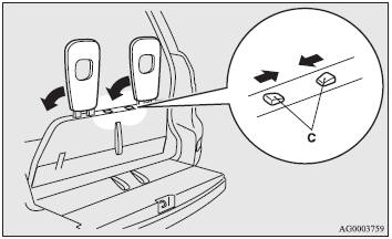 3. Slide the knob while folding the head restraints (C) to the rear, and stow