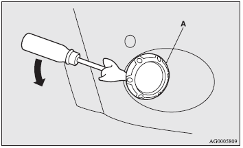 1. Insert a minus screwdriver with the end covered with a cloth or other object